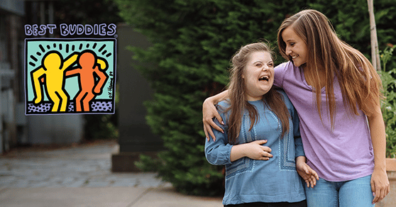 Two female Best Buddies participants hugging